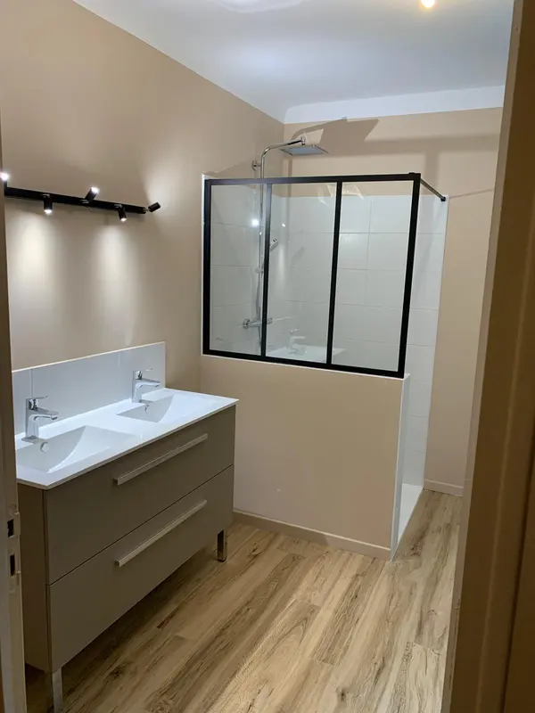 Salle de bains avec sol bois et verrière